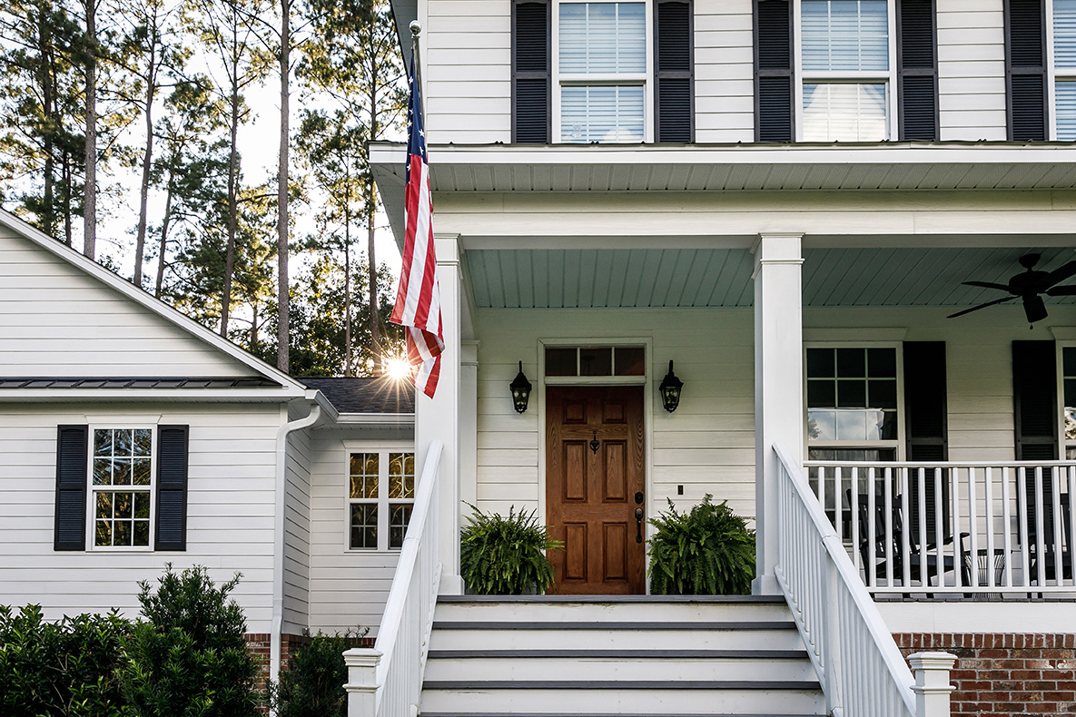 white siding with wood door