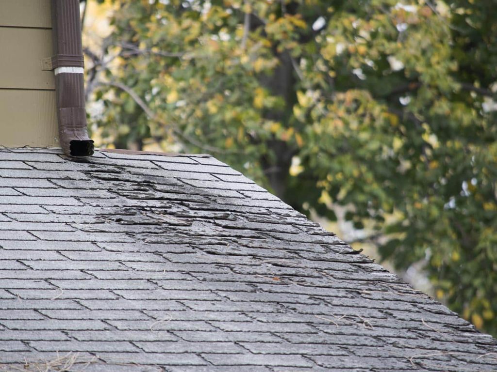 very worn roof on home