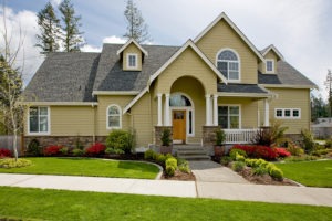 Luxury home exterior with grass and blue sky